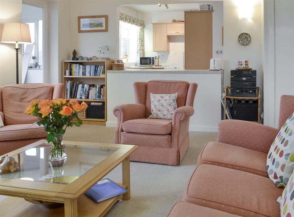 Spacious living area with open view to kitchen at Craigneish Bungalow in Trearddur Bay, near Holyhead, Isle of Anglesey, Gwynedd