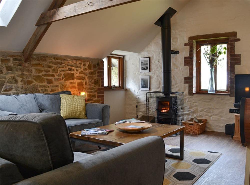 Living room with wood burner at The Old Coach House, 