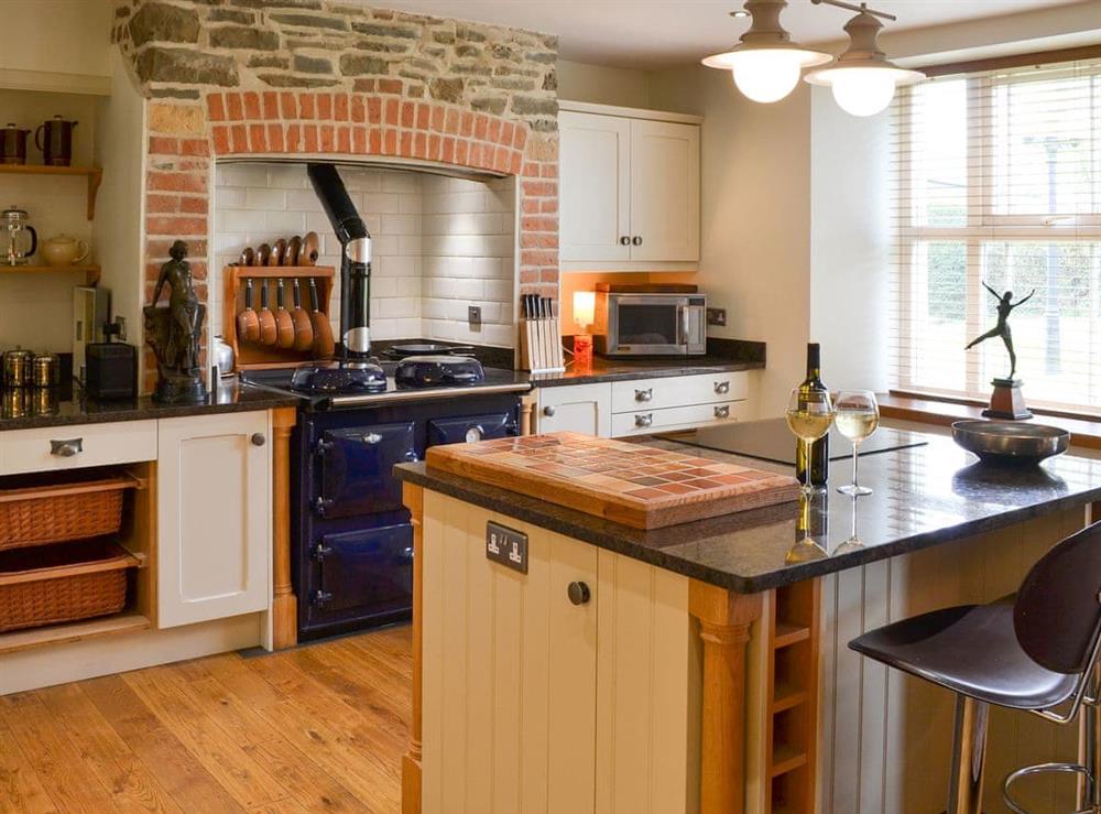 Farmhouse style kitchen area with oil-fired range at Cranford House in Cranford, near Clovelly, Devon
