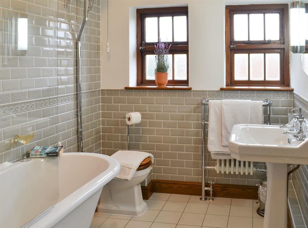 Spacious bathroom with shower over claw-foot bath at Cranford House in Cranford, near Clovelly, Devon