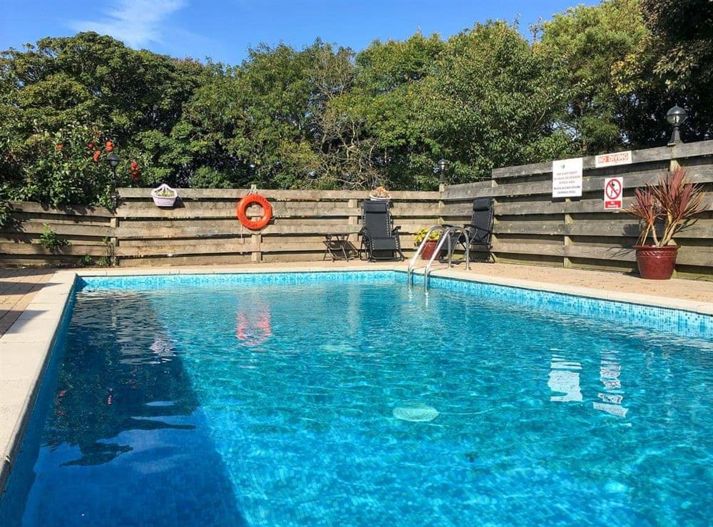 Shared, heated swimming pool at Crantock Cottage in Goonhavern, near Newquay, Cornwall