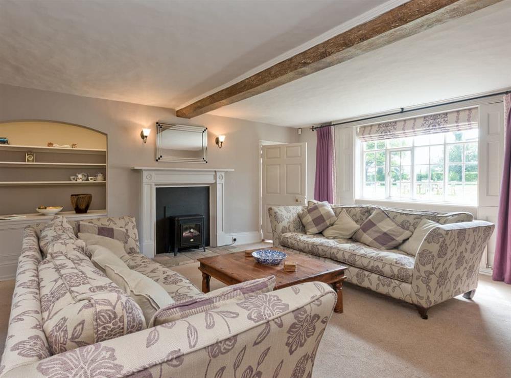 Spacious sitting room equipped with electric woodburner (photo 2) at Cravens Manor in Henham, near Southwold, Suffolk