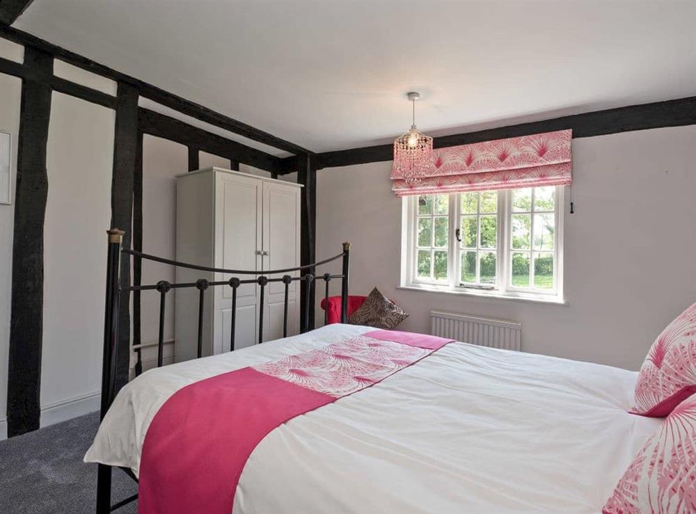 This charming double bedroom has maintained its original features throughout at Cravens Manor in Henham, near Southwold, Suffolk