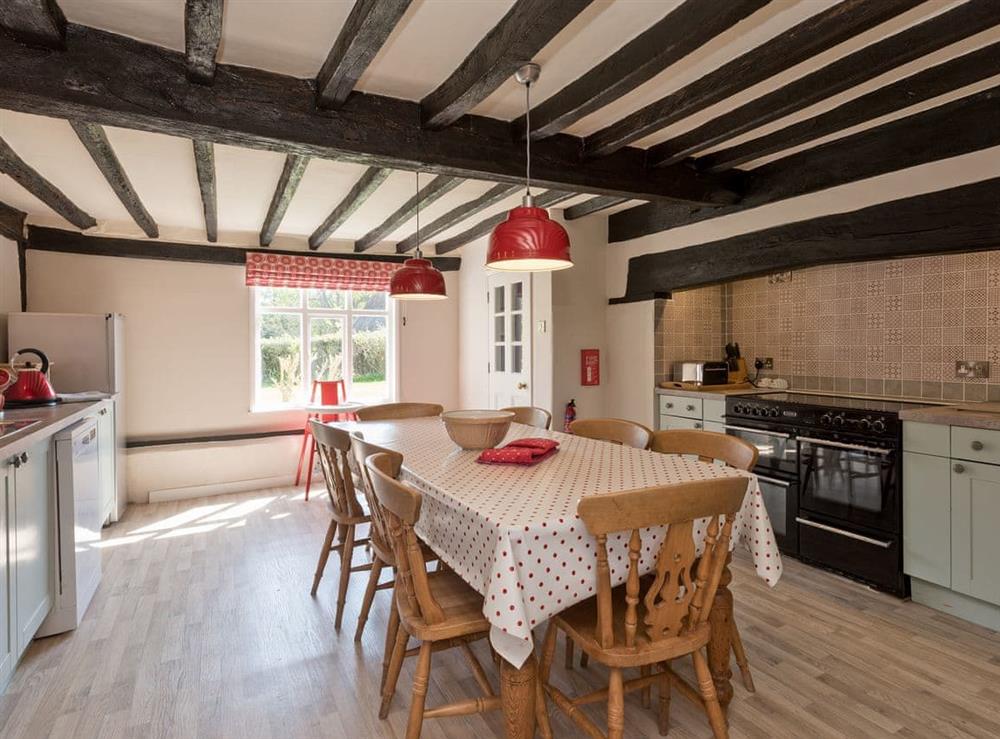 Traditional farmhouse kitchen/dining area with electric range at Cravens Manor in Henham, near Southwold, Suffolk