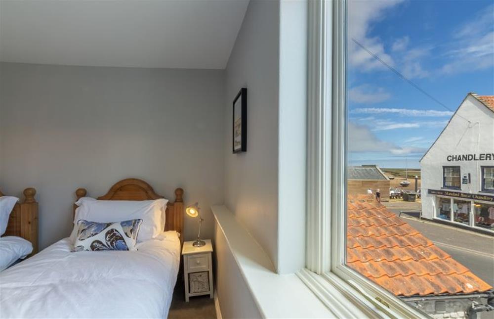 First floor: Bedroom two has glimpses towards the harbour at Creek Cottage, Wells-next-the-Sea