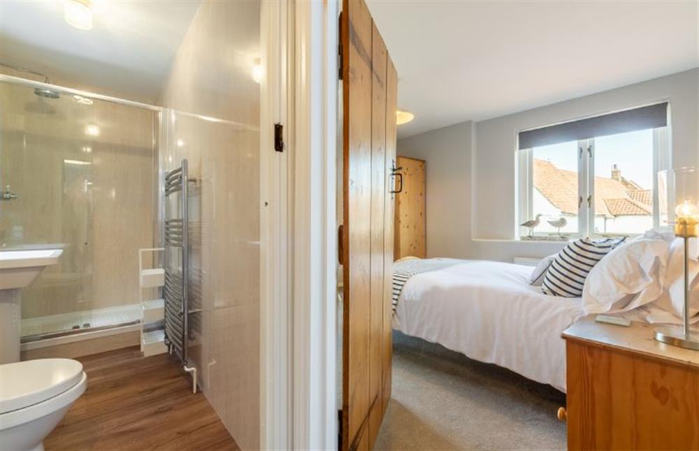 First floor: Shower room and master bedroom at Creek Cottage, Wells-next-the-Sea