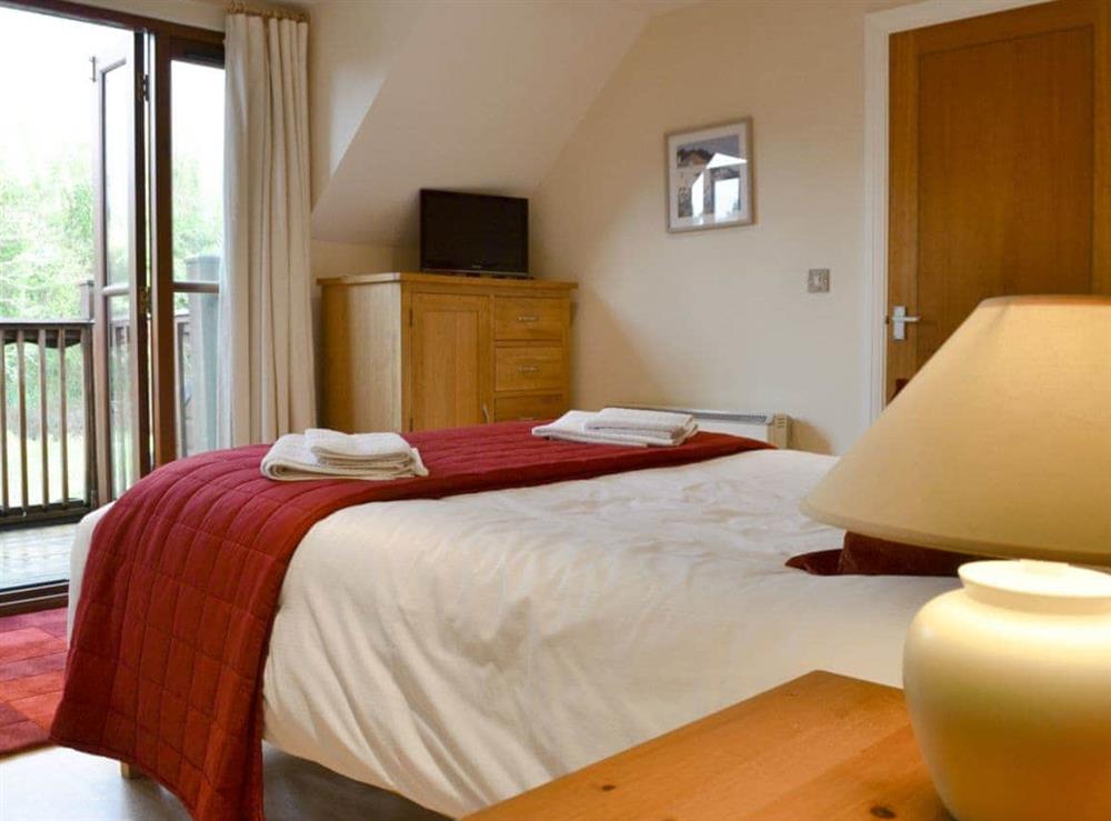 Double bedroom leading onto balcony at Creekside in Wadebridge, near Padstow, Cornwall