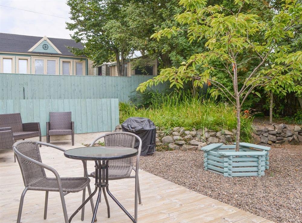 Decked patio area with outdoor furniture at Crew House in Craster, near Alnwick, Northumberland