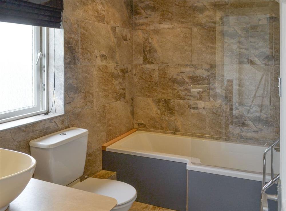 Family bathroom with shower over bath at Crew House in Craster, near Alnwick, Northumberland