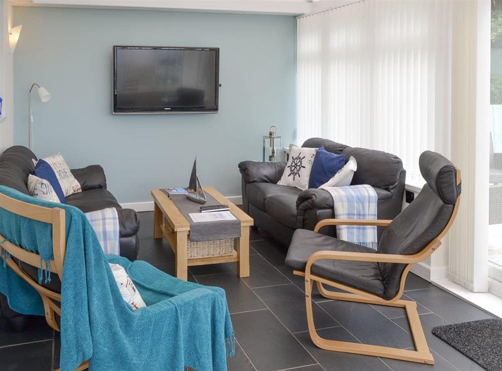 Welcoming living area within conservatory at Crew House in Craster, near Alnwick, Northumberland