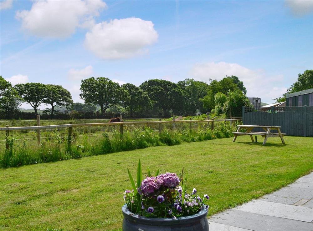Lawned garden with countryside views at Crib Y Nantlle in Pontllyfni, near Caernarfon, Gwynedd