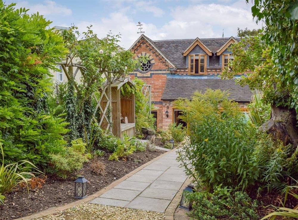 Well-stocked garden, complete with an arbour, rose garden and private patio area at Cricket Cottage in Ebrington, Nr Chipping Campden, Glos., Gloucestershire