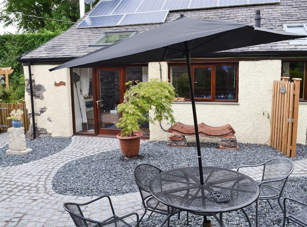 Courtyard with seating area at Crimson Cottage in Broughton-in-Furness, Cumbria