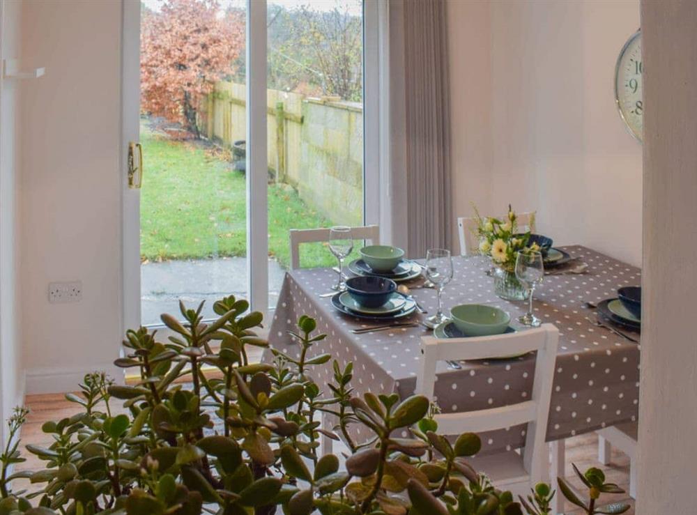 Dining room with sliding doors to the garden at Croft Cottage in Newholm, near Whitby, North Yorkshire