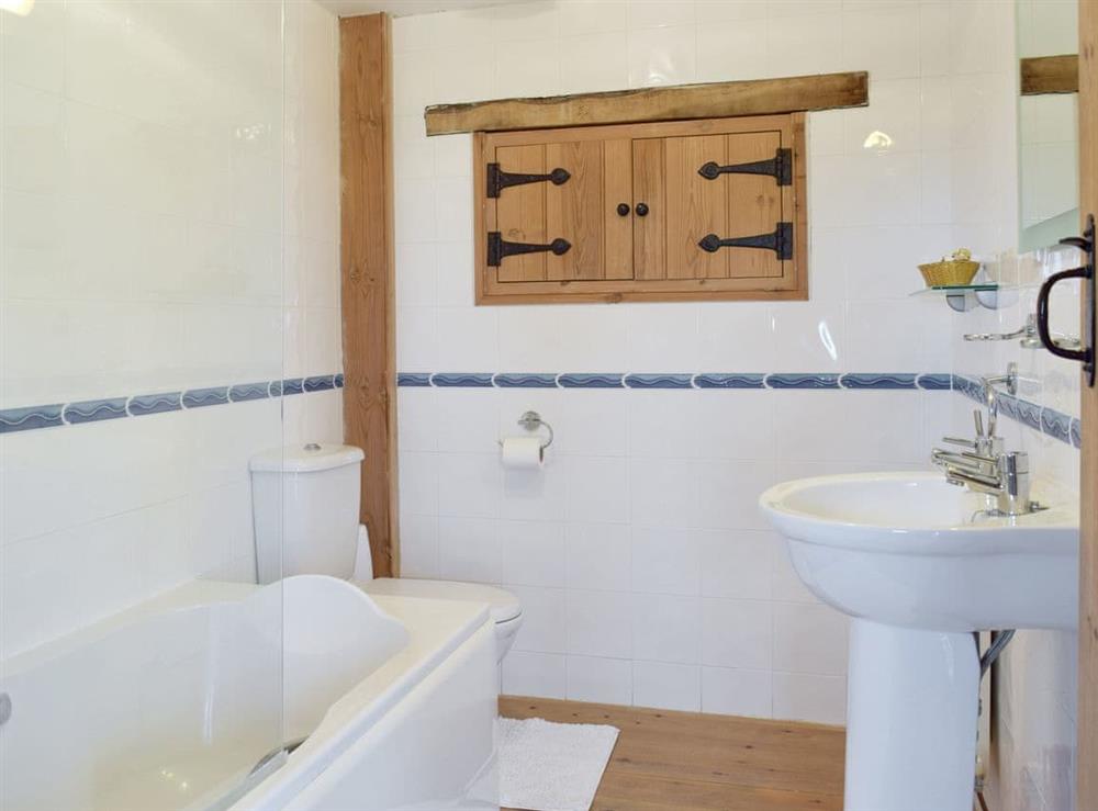 Bathroom with shower over bath at Hayloft Cottage, 