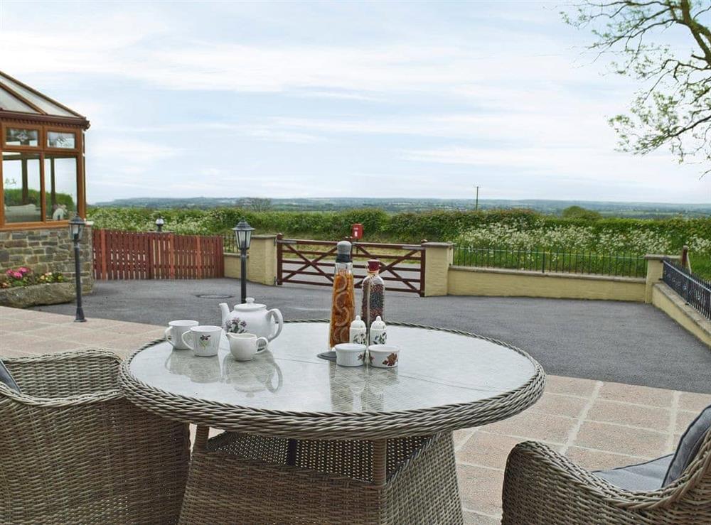 Relaxing sitting-out-area with lovely views at Hayloft Cottage, 