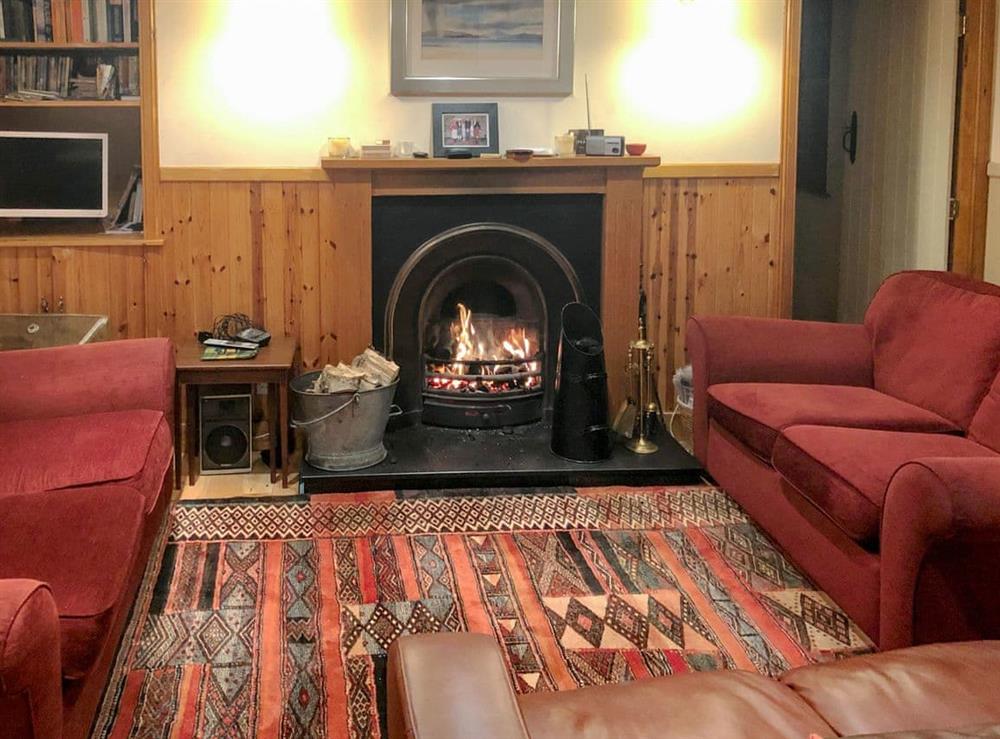 Cosy living room with an open fire (photo 2) at Crofts in Glenbuchat, Aberdeenshire
