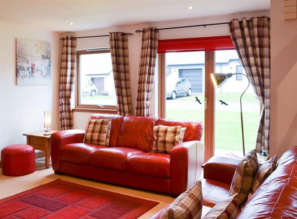 Comfortable leather sofas in the living room at Croftside House in Aviemore, Inverness-Shire