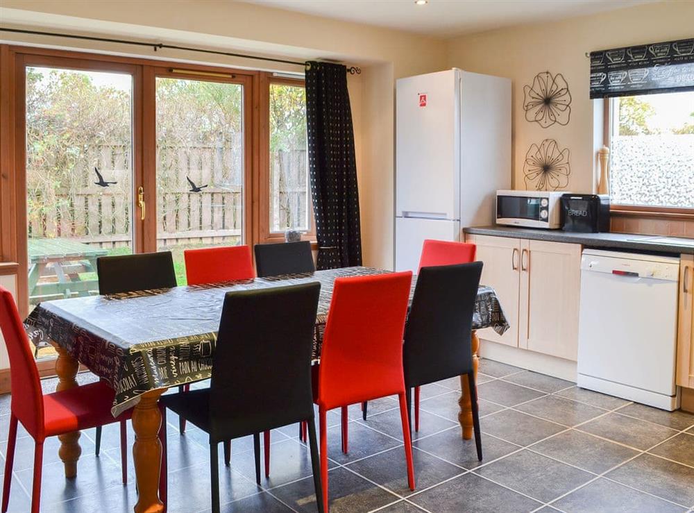 Large kitchen/diner with doors to the garden at Croftside House in Aviemore, Inverness-Shire