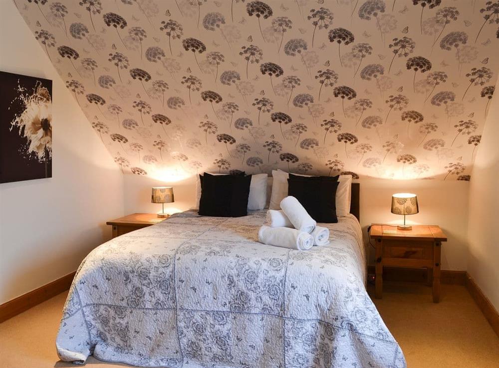 Roomy double bedroom with sloping ceiling at Croftside House in Aviemore, Inverness-Shire