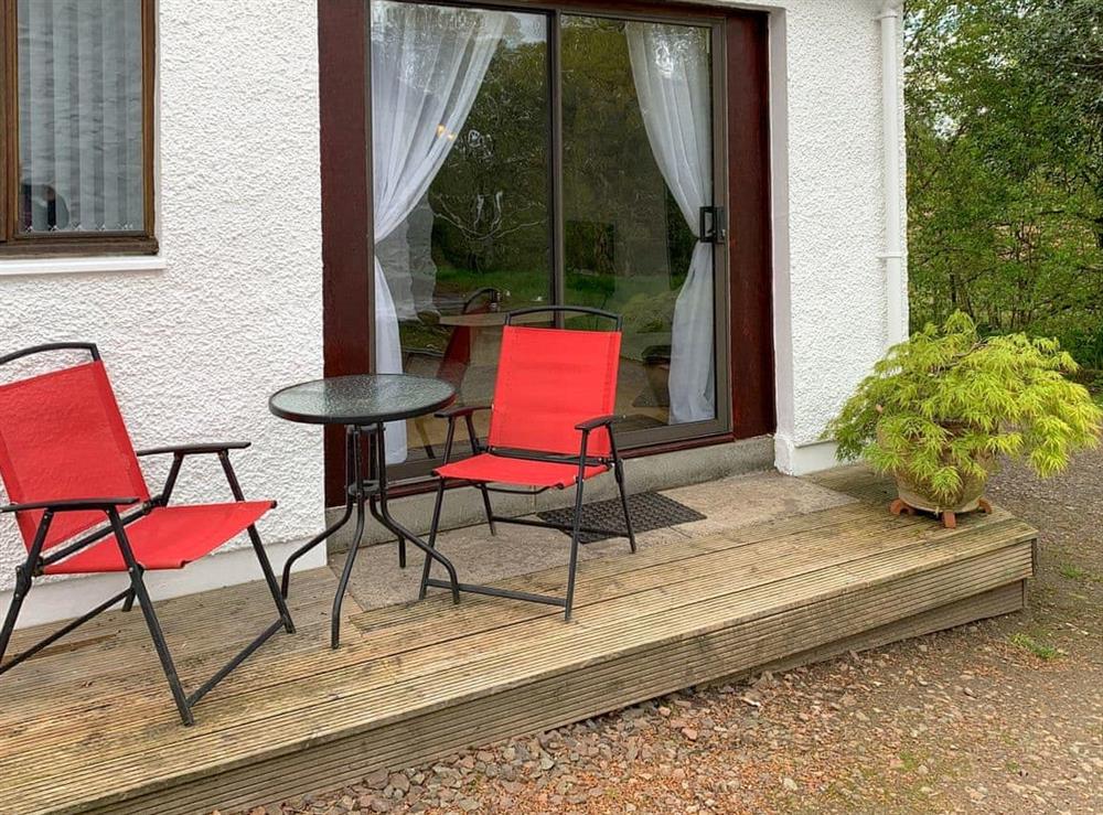 Decked patio area looking out on to unspoilt woodland grounds at Crossburn Hideaway in Arden, near Helensburgh, Argyll and Bute, Dumbartonshire
