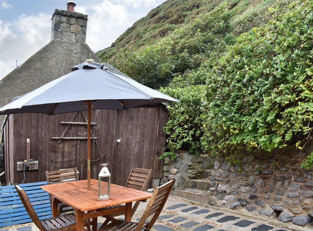 Useful patio area at rear of property at Crovie in Crovie, Gardenstown, Banffshire