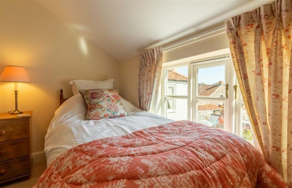 First floor:  Bedroom 3 with a small 4ft double bed and a window overlooking the Buttlands at Crown Villa, Wells-next-the-Sea