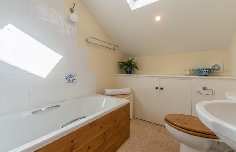 First floor:  Family bathroom with towel rail and storage cupboard at Crown Villa, Wells-next-the-Sea