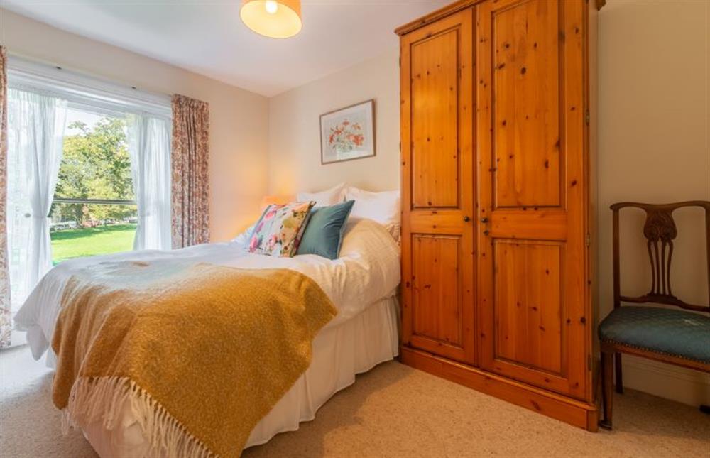 First floor:  Master bedroom with large window overlooking the Butlands at Crown Villa, Wells-next-the-Sea