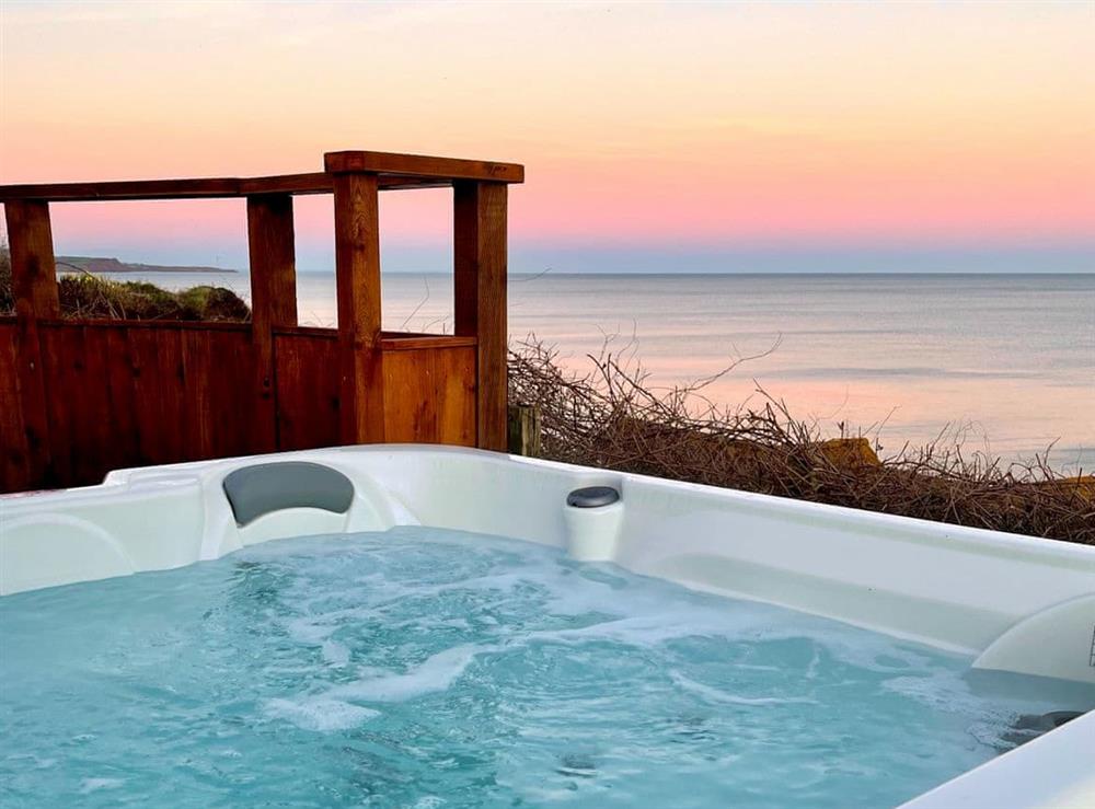 Enjoy sunset with wraparound sea views from the luxury hot tub at Crows Nest in Dawlish, Devon