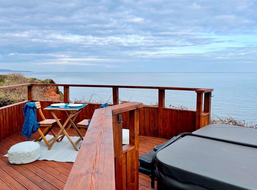 Even on a cloudy day, enjoy spectacular views of the sea and coastline towards Exmouth at Crows Nest in Dawlish, Devon