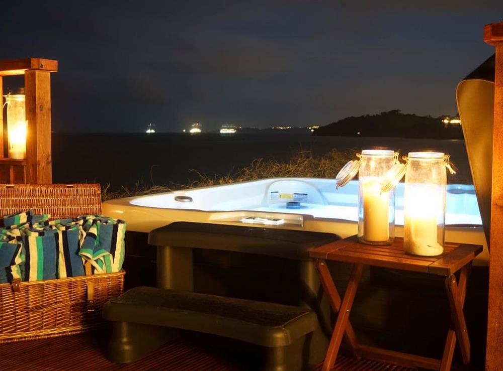 Listen to the waves and enjoy endless skies and sea views from your own hot tub at night at Crows Nest in Dawlish, Devon