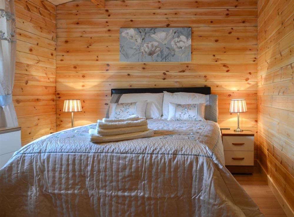 Romantic and inviting double bedroom at Cruachan Log Cabin in Banavie, near Fort William, Inverness-Shire