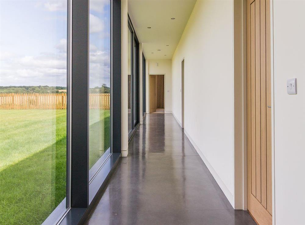 Corridor with impressive glass wall at The Cotswolds Barn, 