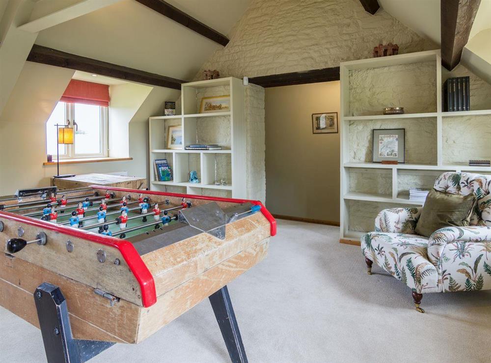 Sitting room area with table football game at The Long Barn, 