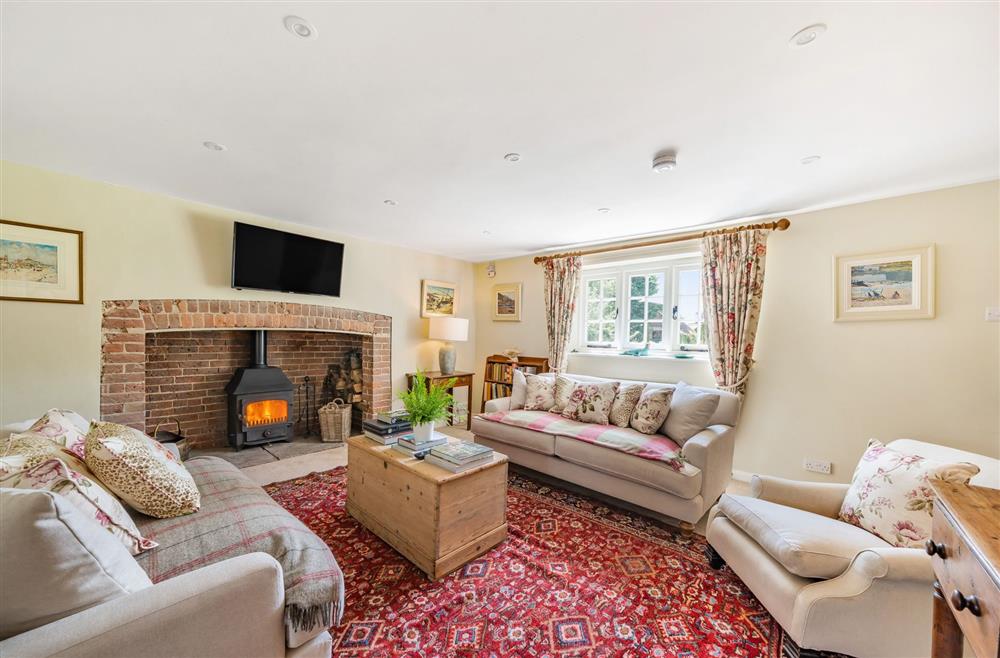 The attractive sitting room with wood burning stove at Crumpet Cottage, Dorchester