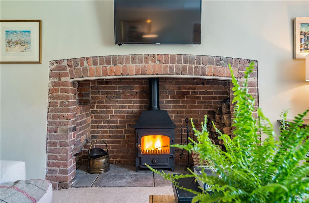 With the original exposed brickwork fireplace at Crumpet Cottage, Dorchester