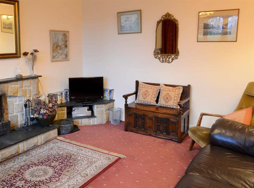 Comfortable living room with open fire (photo 2) at Culcharry Cottage in Cawdor, Nairn, Highland