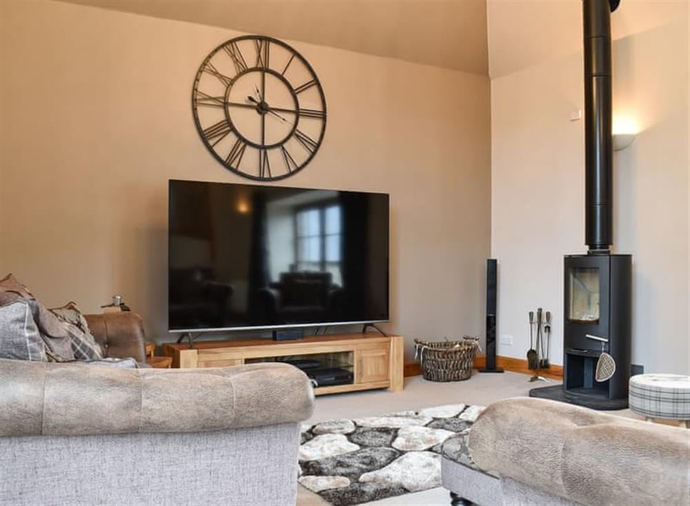 Lounge area with large TV and wood burner at Culdrain Steading in Gartly, near Huntly, Aberdeenshire