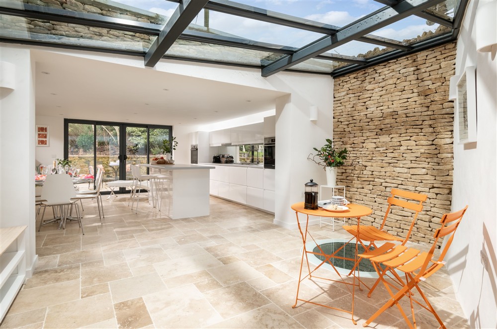 The re-designed, spectacular kitchen/dining area with glazed link featuring  a covered well at Culls Cottage, Southrop