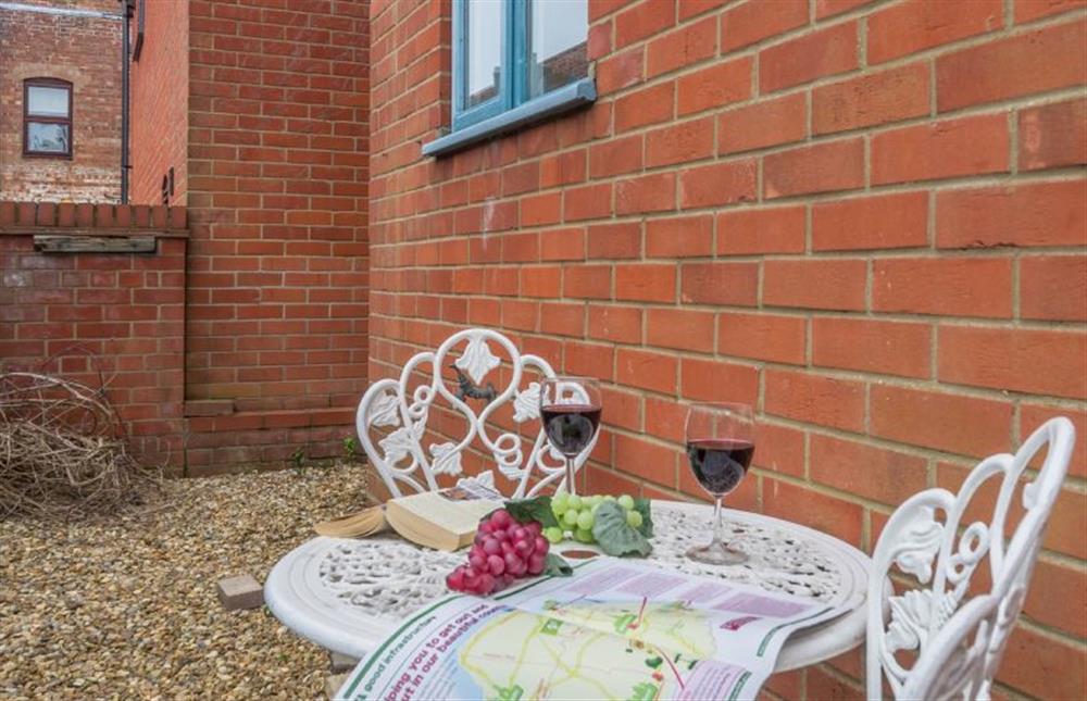 The courtyard garden is shared with Avocet Apartment, each with their own table at Curlew Apartment, Wells-next-the-Sea