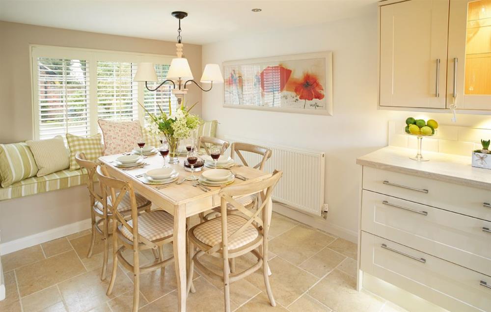 Kitchen with dining area and window seat at Curlew Cottage, Lower Peover