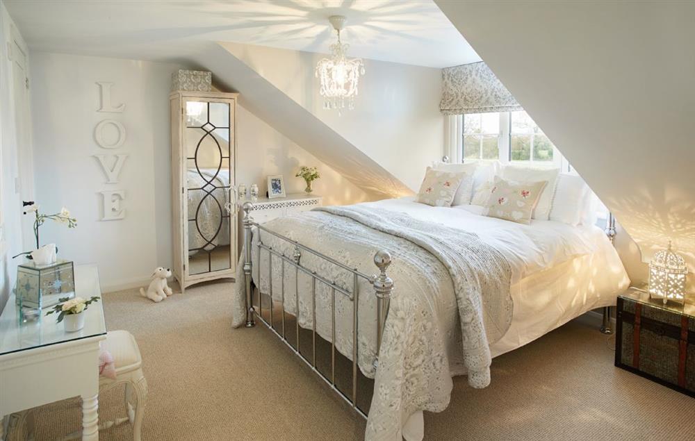 Romantic bedroom with a king-size bed and en-suite shower room at Curlew Cottage, Lower Peover