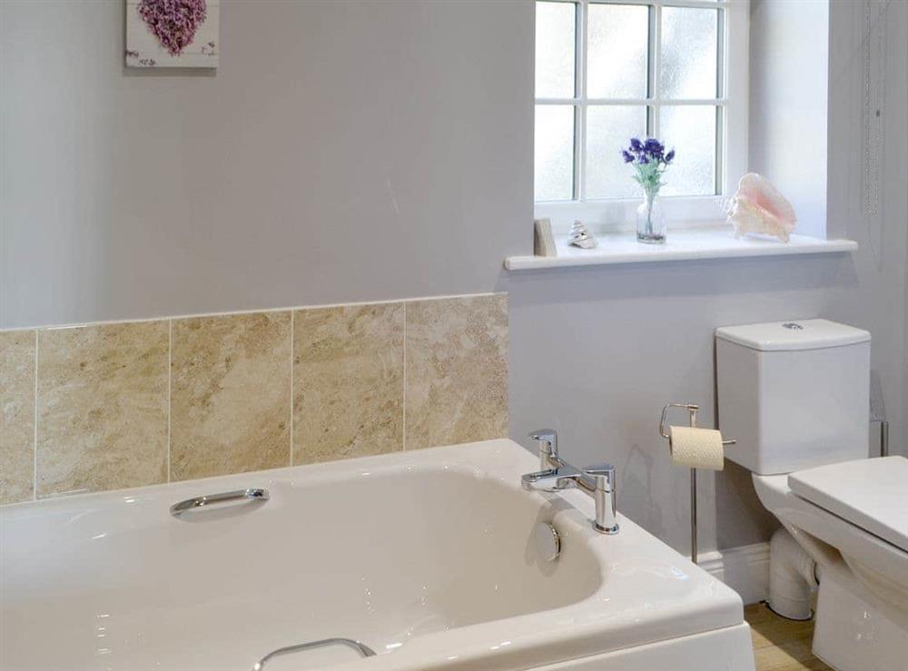 Family bathroom with bath and large shower cubicle at Curlew Cottage in Near Bellingham, Northumberland