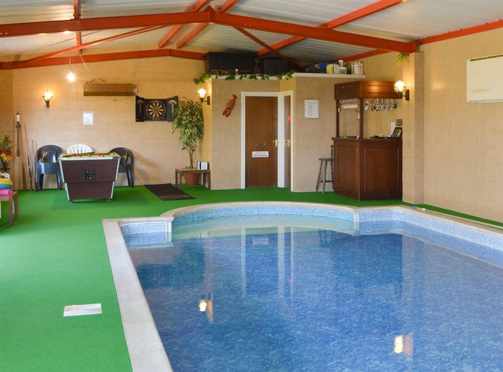 Private indoor swimming pool with games area and bar at Curlew Cottage in Near Bellingham, Northumberland