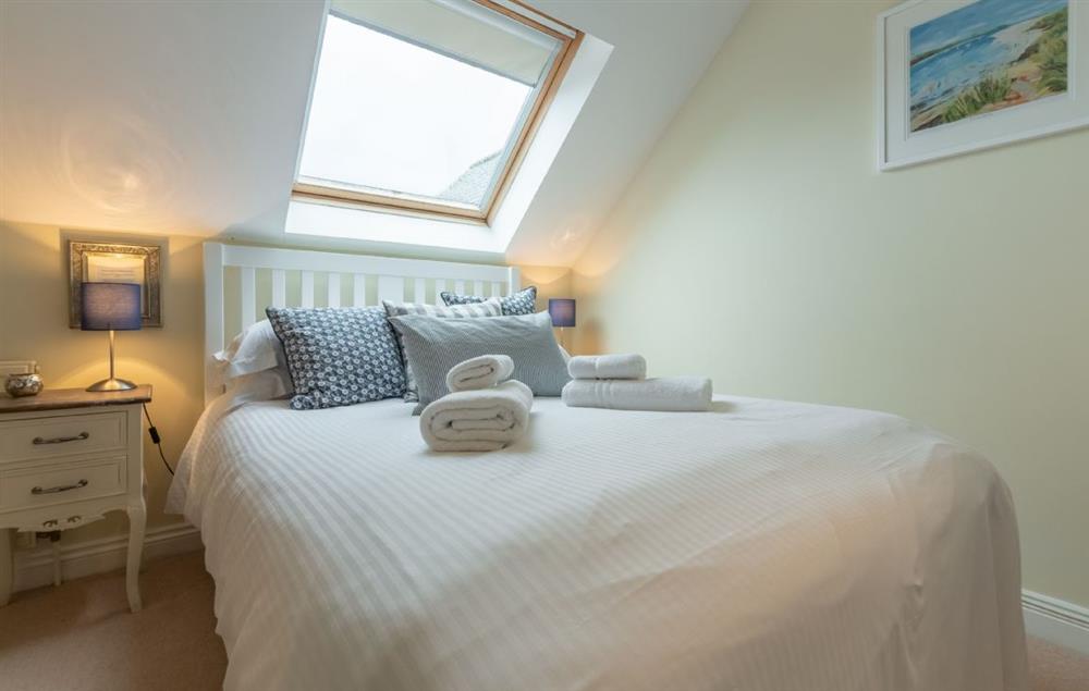 Bedroom with double bed and en-suite shower room at Curlews Cwtch, Roserrow