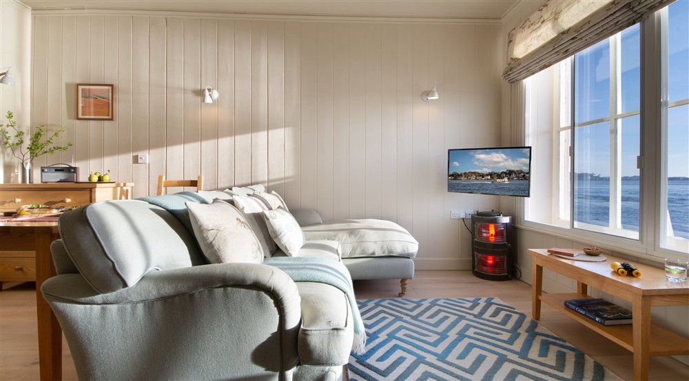 The open plan sitting, dining and bedroom at Custom House in Poole, Dorset
