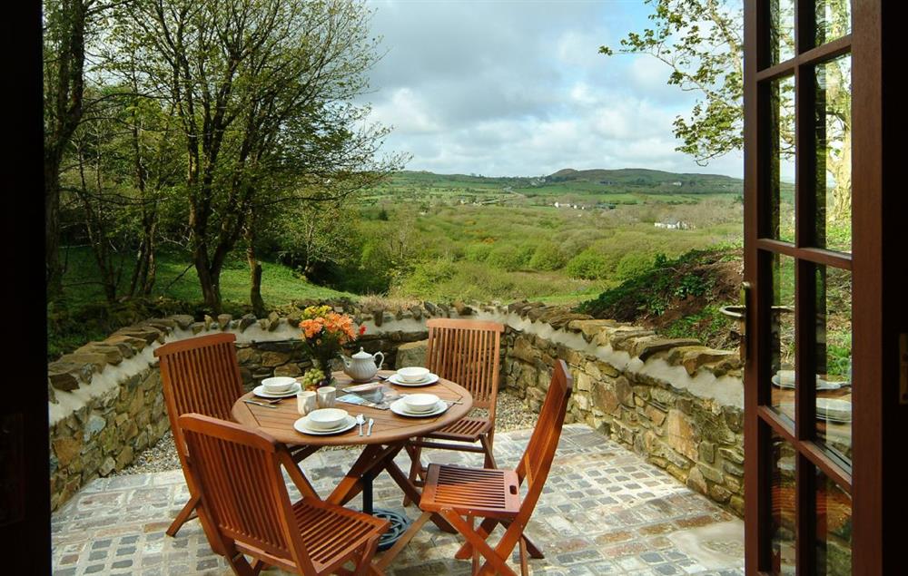 French doors from sitting room to patio with barbecue at Cwm Bach, Dinas Cross