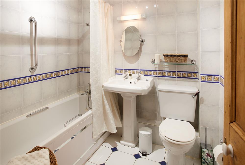 En-suite bathroom with bath and shower over at Cygnet Apartment, Harrogate