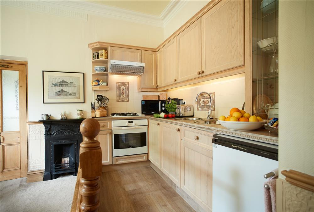 Galley kitchen raised above the dining area at Cygnet Apartment, Harrogate
